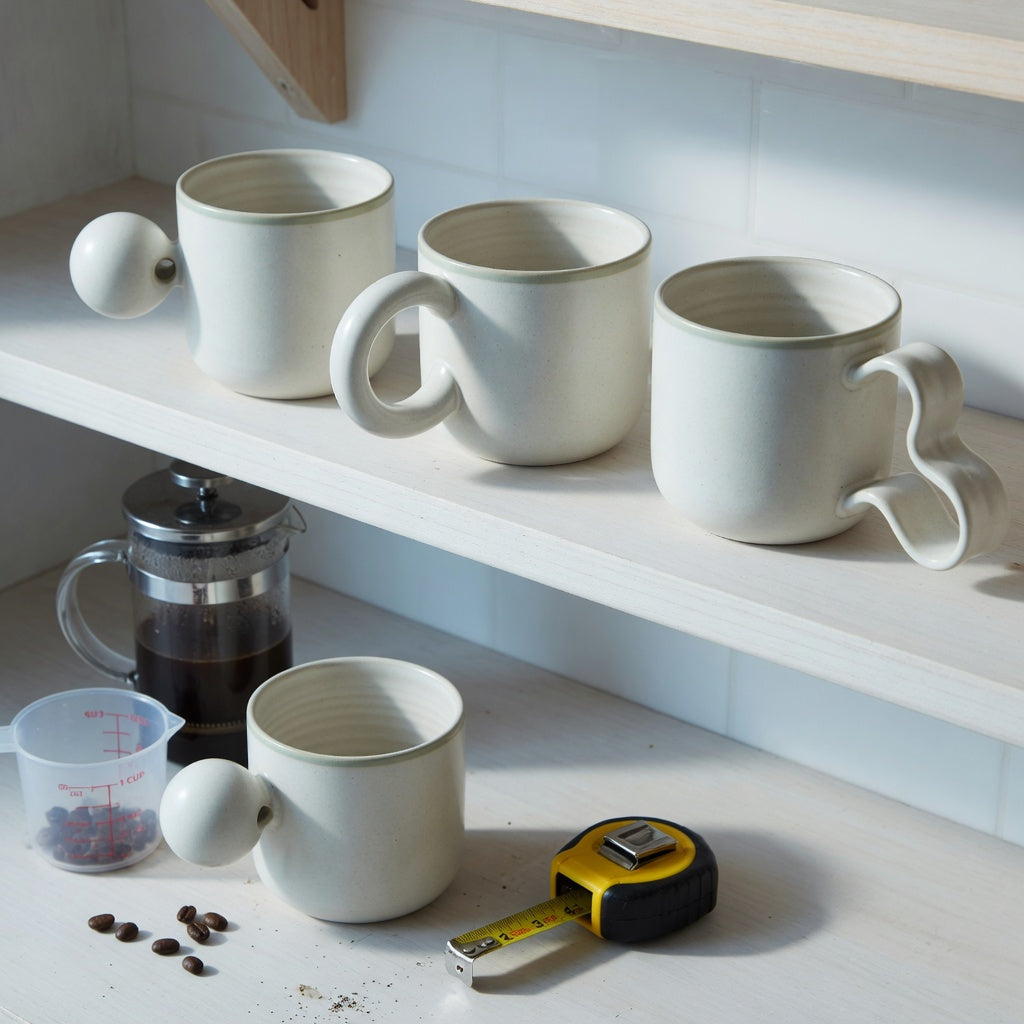 ceramic coffee mug with handle everyday mug rotation practical purchase checklist showing ball, round, and flowing handle forms on a kitchen shelf