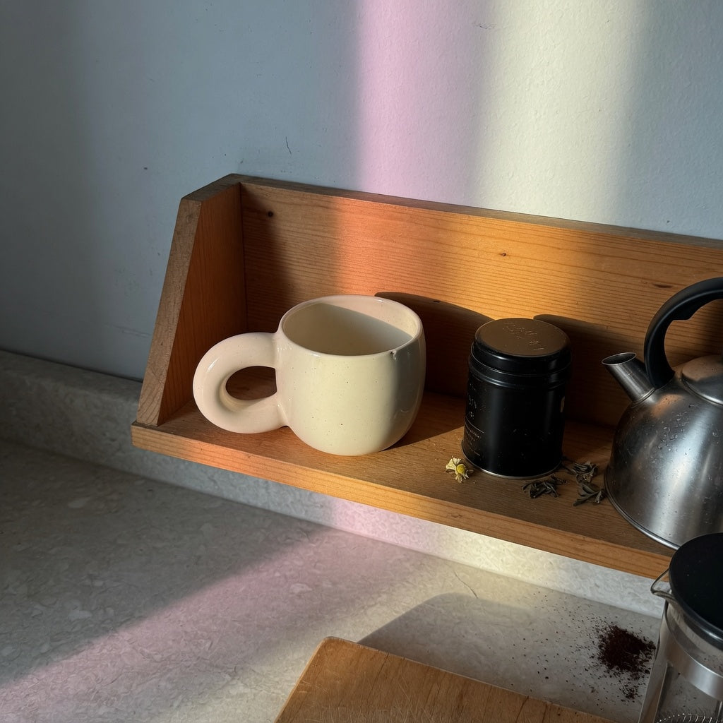 Ball-handled coffee tea mug gift for home decor on an open kitchen shelf beside a kettle