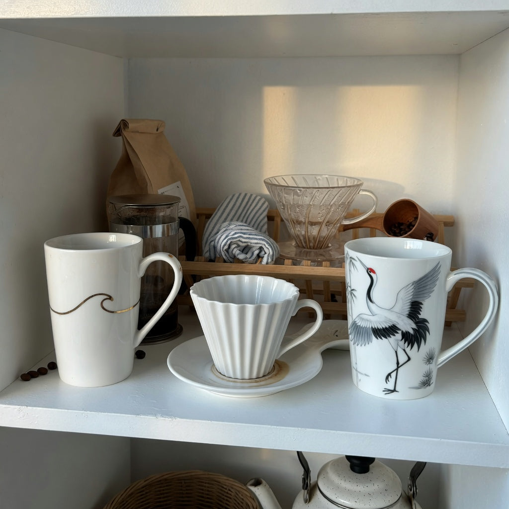 white pottery coffee mugs everyday mug rotation practical purchase checklist shown with tall, pleated, and crane-design mugs on an open kitchen shelf