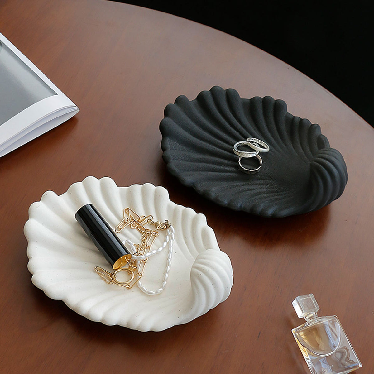 Black and white shell trays on a dressing table