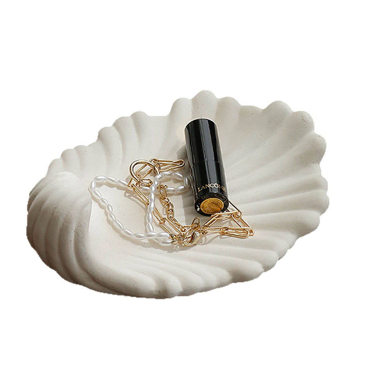 White shell shaped ceramic tray with jewelry styling props