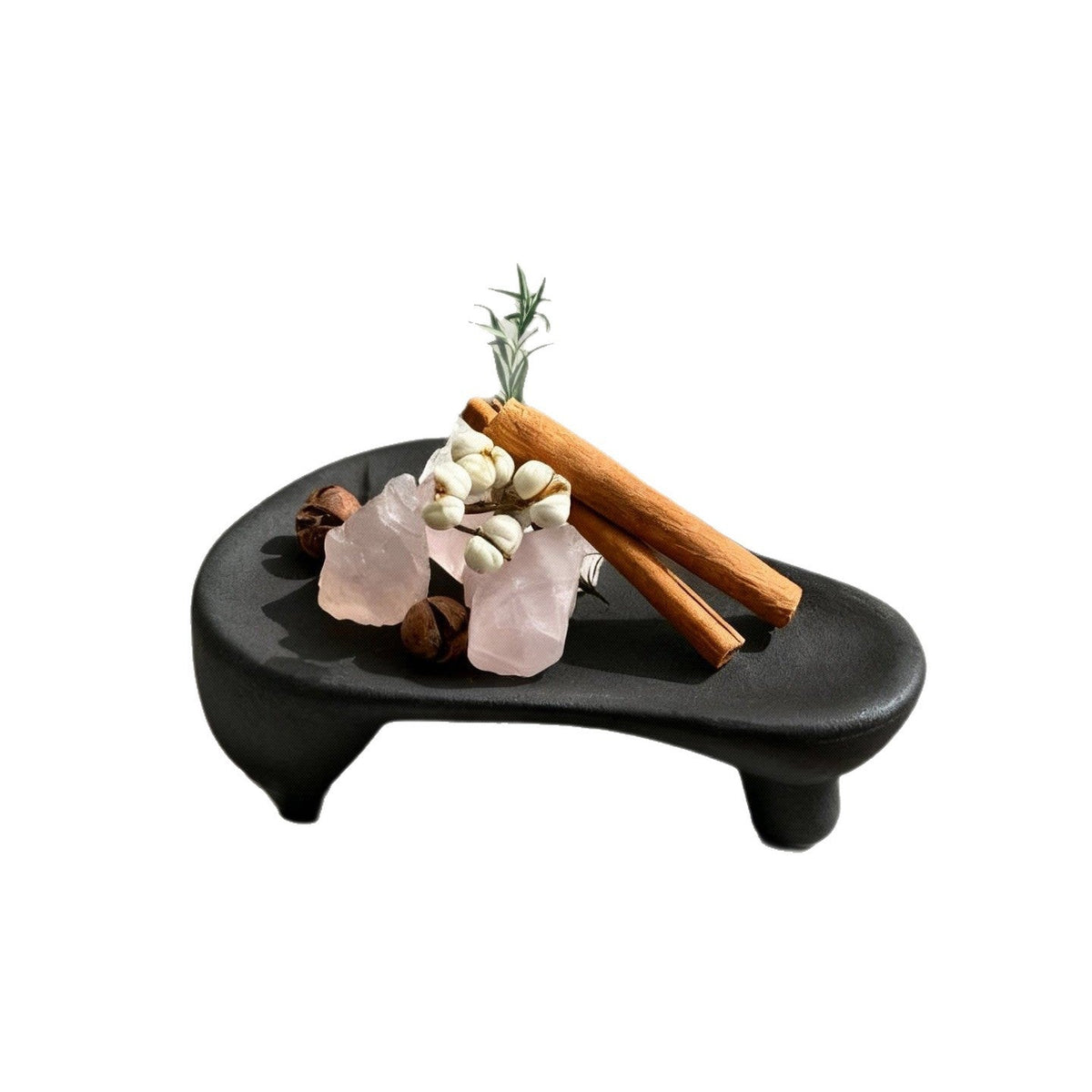 Black triangular ceramic trinket tray with three short feet