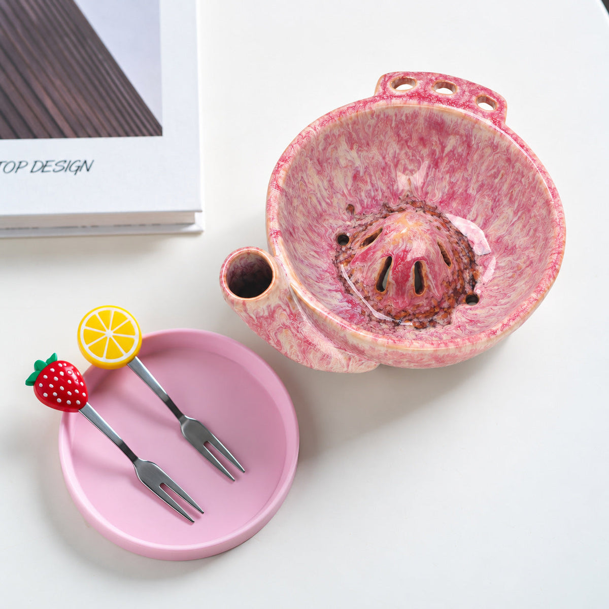Top view of a rose pink berry bowl showing drainage openings