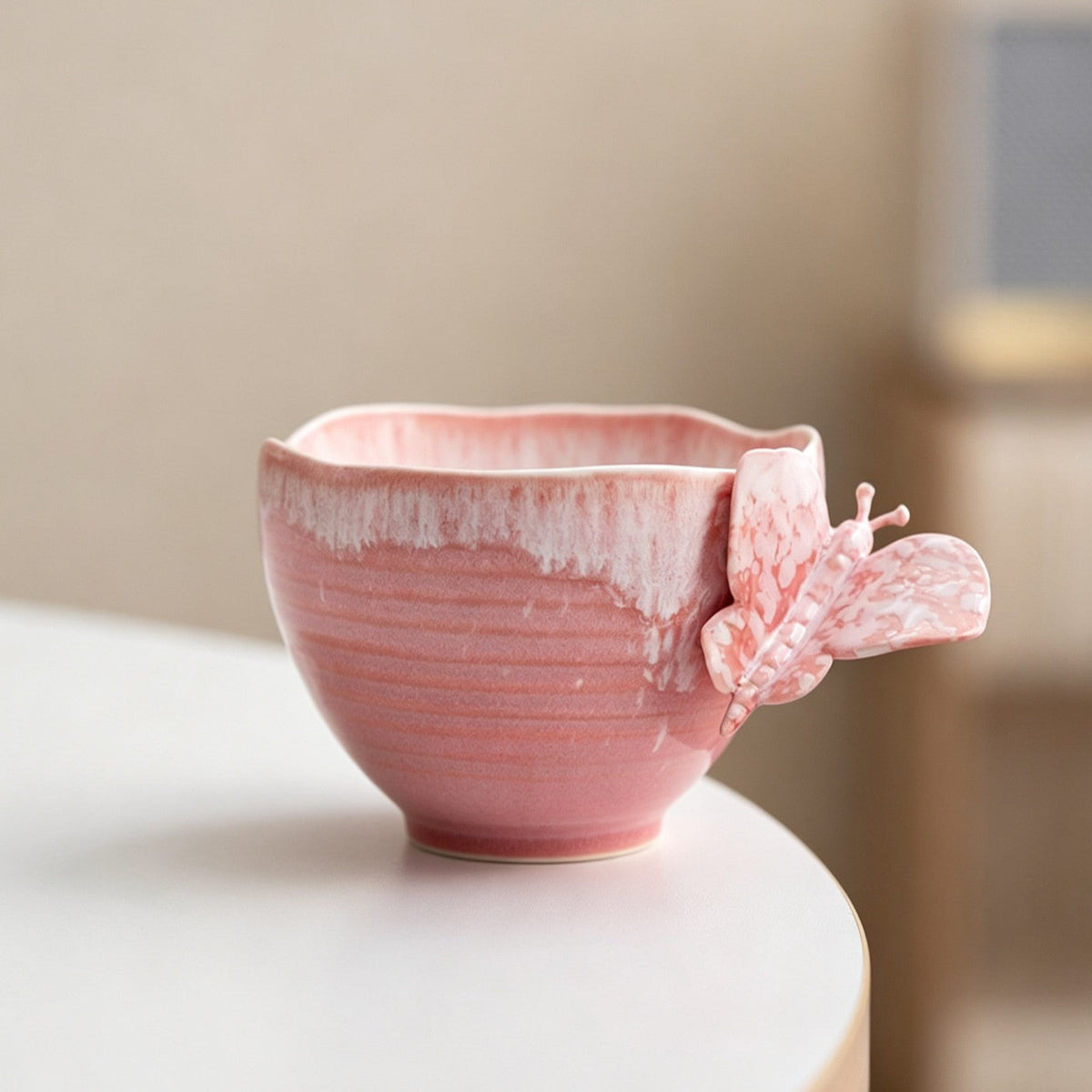 Pink ceramic cup with sculpted butterfly handle
