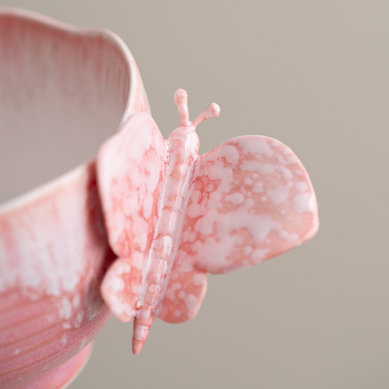 Close view of the pink butterfly handle and reactive glaze