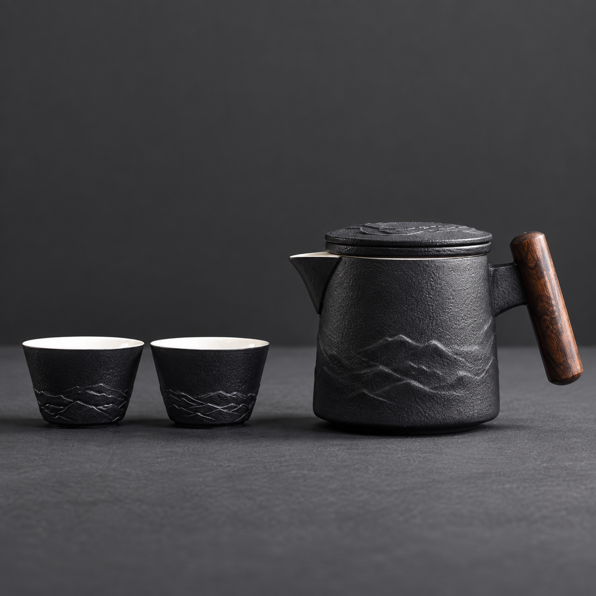 Black mountain relief ceramic travel teapot with two matching cups