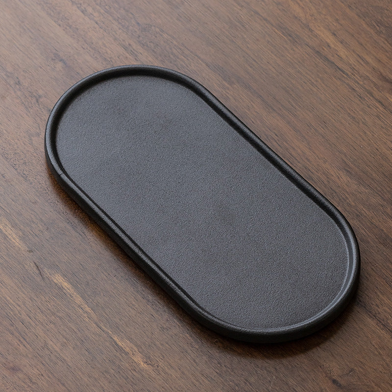 Black oval ceramic tea tray