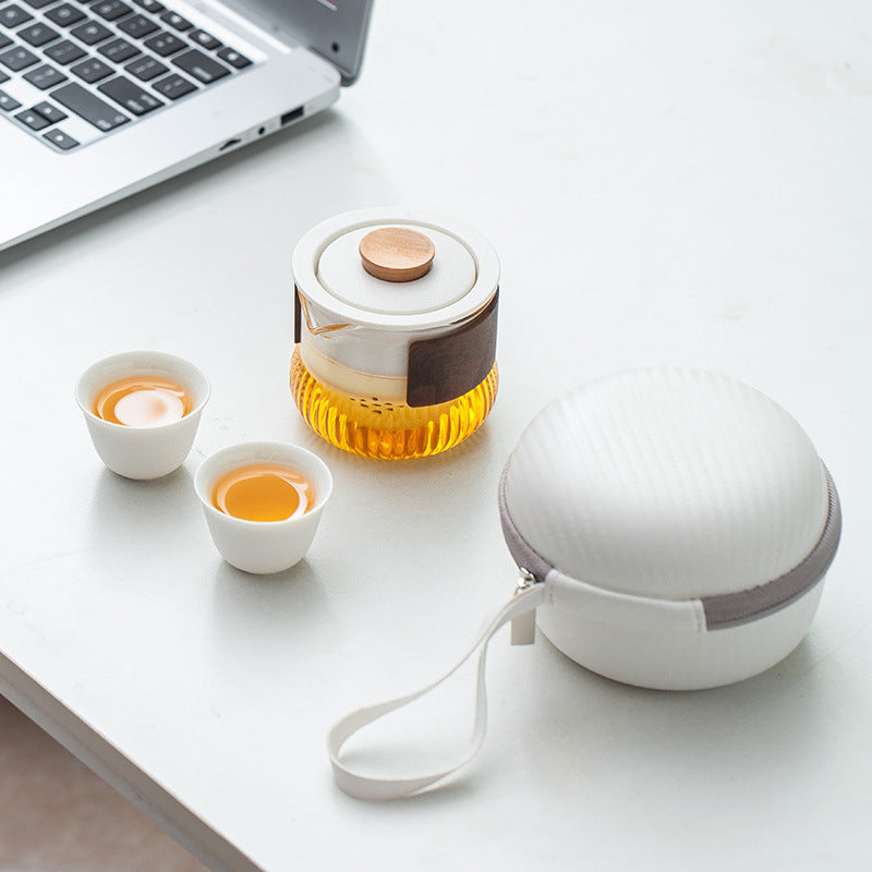 White two cup travel tea set beside its round zippered case