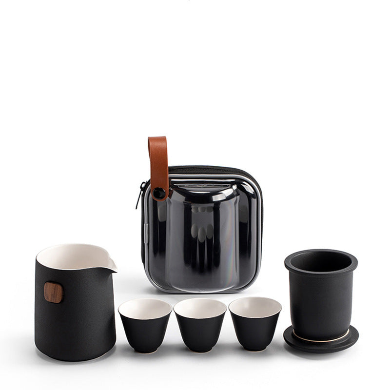Black ceramic travel tea set with server, removable infuser, lid, three cups and clear zip case