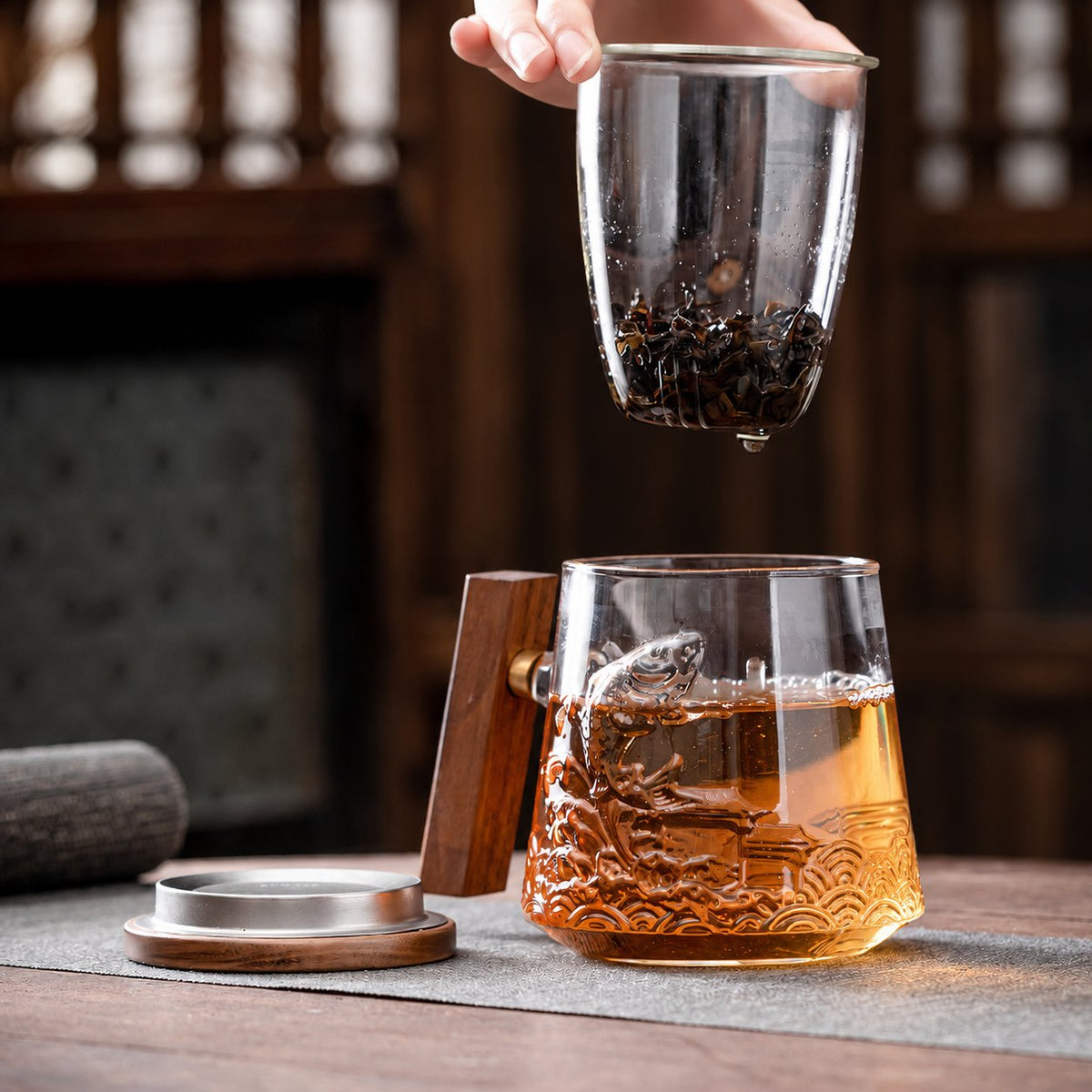 Tea infuser lifted out of the koi glass mug
