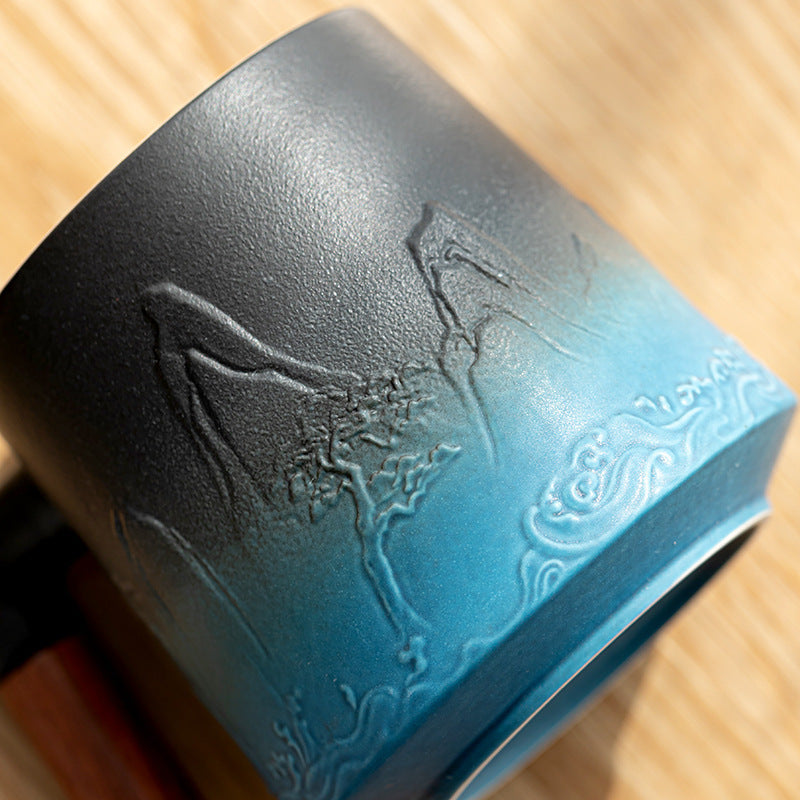 Close-up of mountain and wave relief on blue ceramic mug