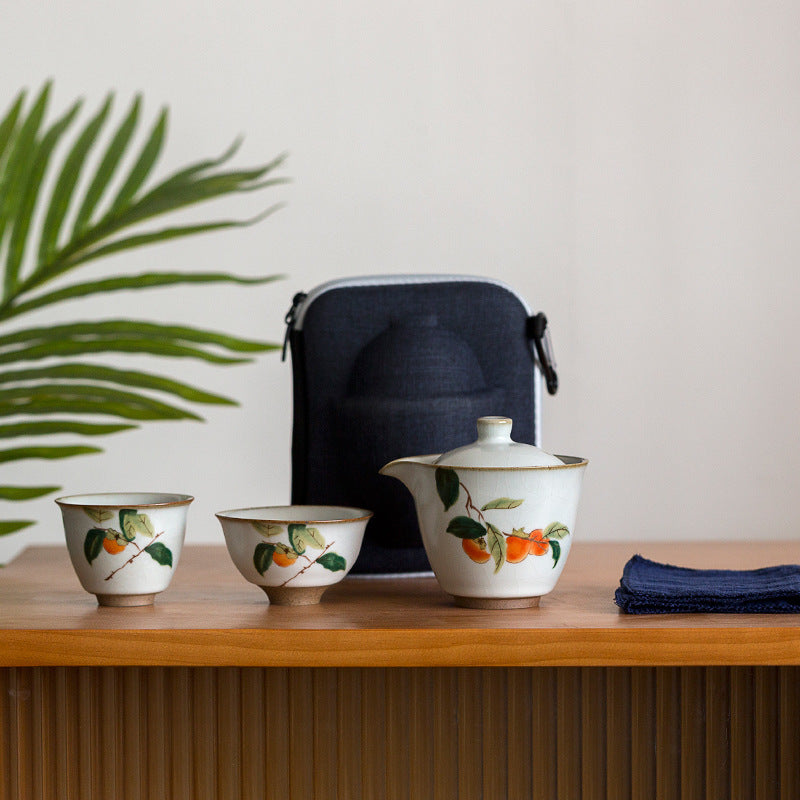 Persimmon ceramic travel tea brewer, two cups and blue carrying case