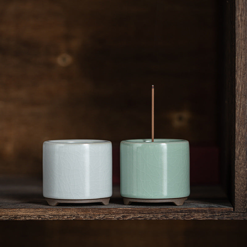 White and celadon ceramic incense holders side by side
