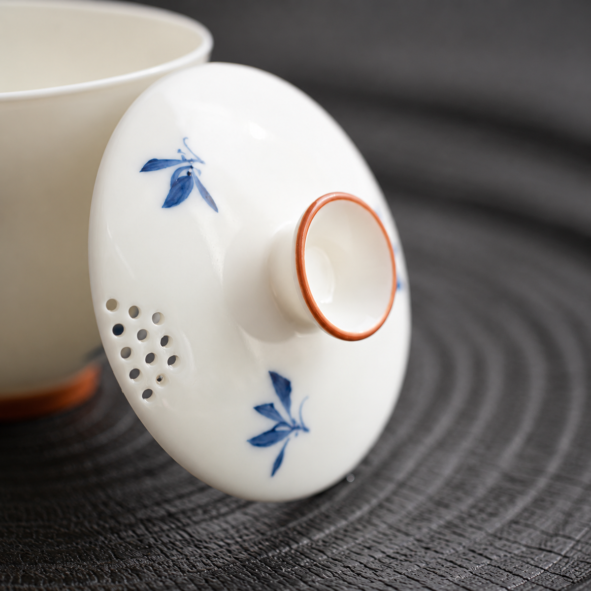 Close view of the blue floral ceramic lid with its built-in strainer holes