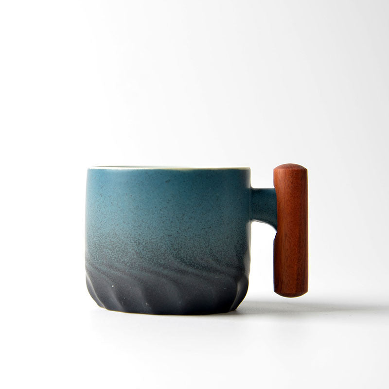 Blue gradient ceramic tea cup with a wooden handle