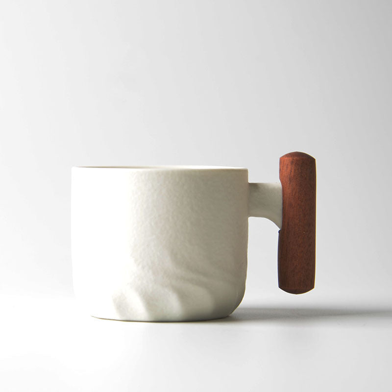 White ceramic tea cup with a vertical wooden handle
