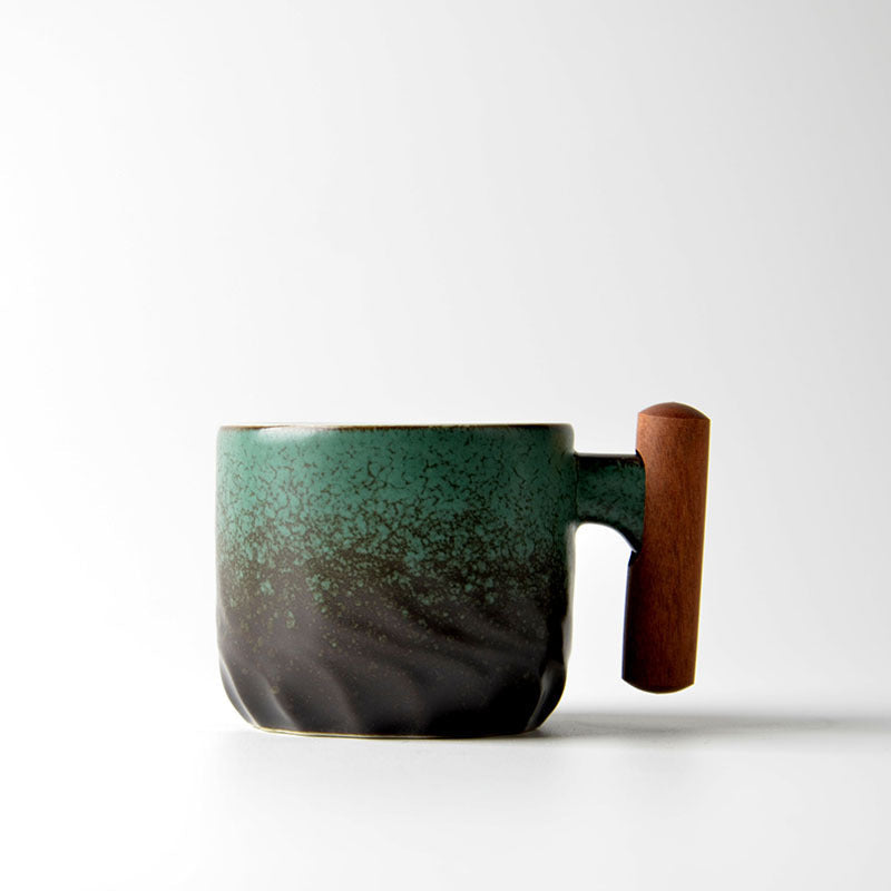 Green gradient ceramic tea cup with a wooden handle