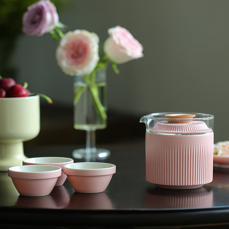 Pink ribbed ceramic travel tea set arranged for a tea break