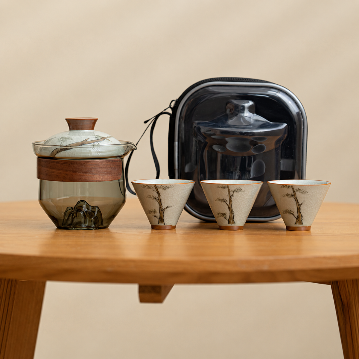 Pine / Smoke glass tea brewer with three patterned ceramic cups and a black travel case