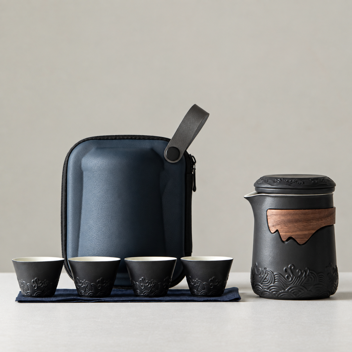 Black travel tea set with its included pieces and actual carrying packaging