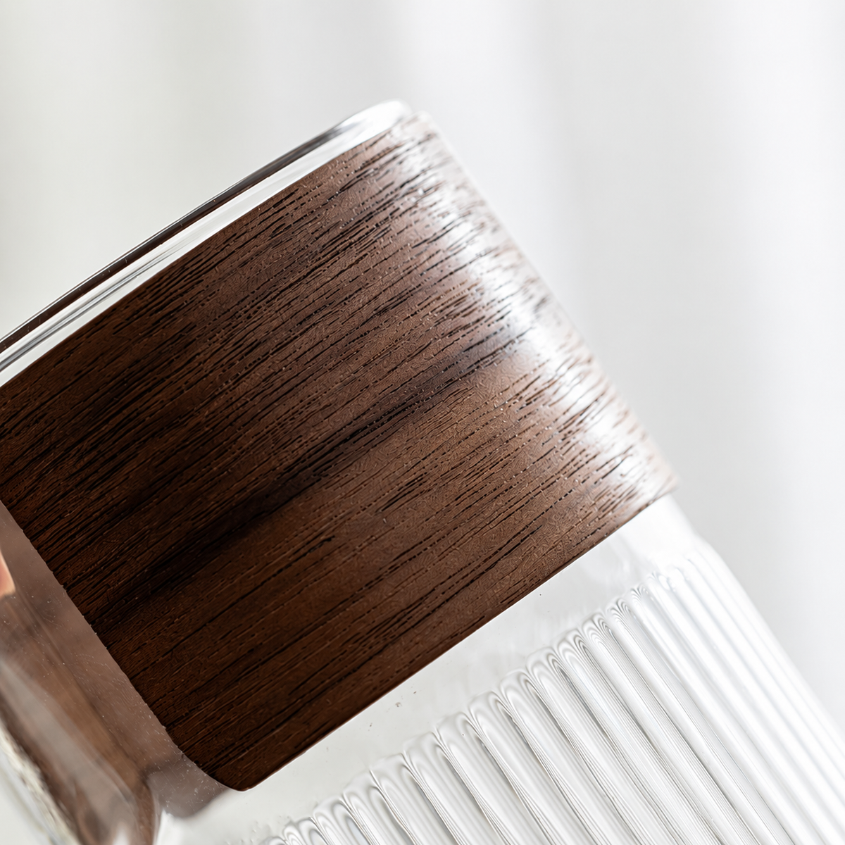 Close view of the wooden grip and ribbed glass brewer
