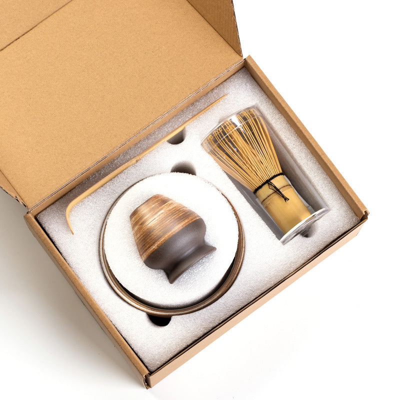 Warm striped ceramic matcha set arranged in its open box