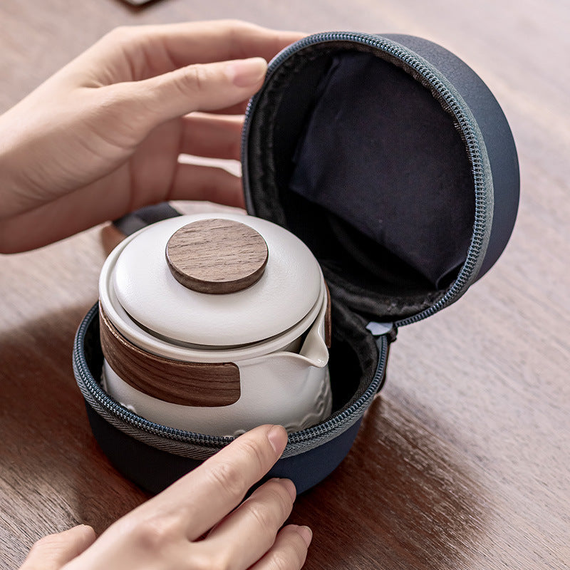 Hands opening the navy zip case to show the white brewer stored inside