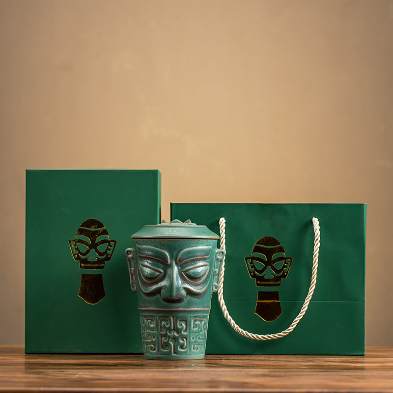 Mask ceramic tea cup with matching green gift box and bag