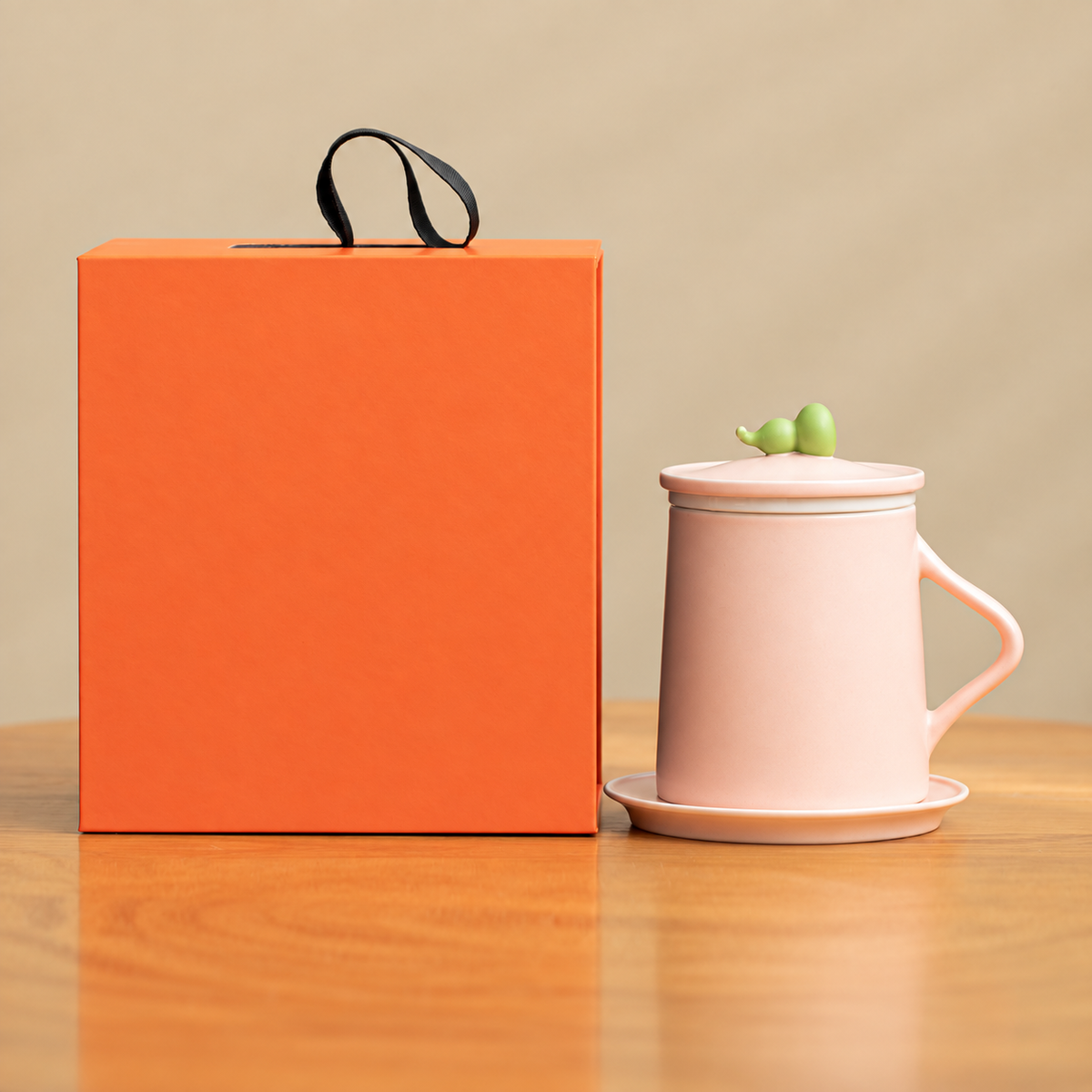 Pink gourd-knob ceramic infuser mug with ceramic handle, saucer and orange gift box
