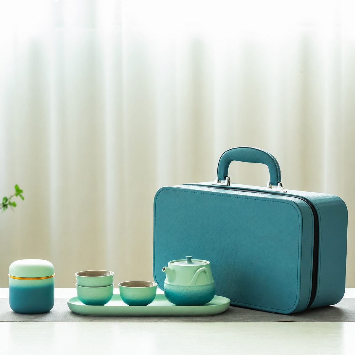Teal gradient travel tea set with one teapot, three cups, tea jar, tray and fitted case