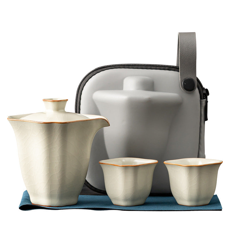 Complete cream square travel tea set with two cups and molded gray case on a white background