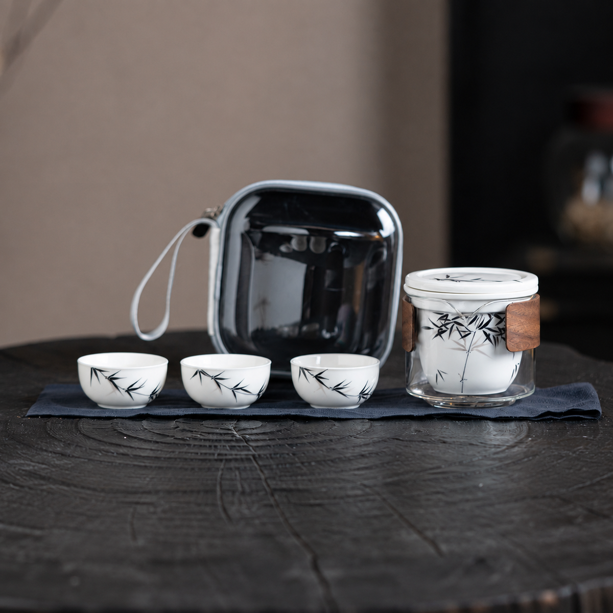 Black bamboo-painted ceramic infuser with glass server, three cups, cloth and translucent dark travel case