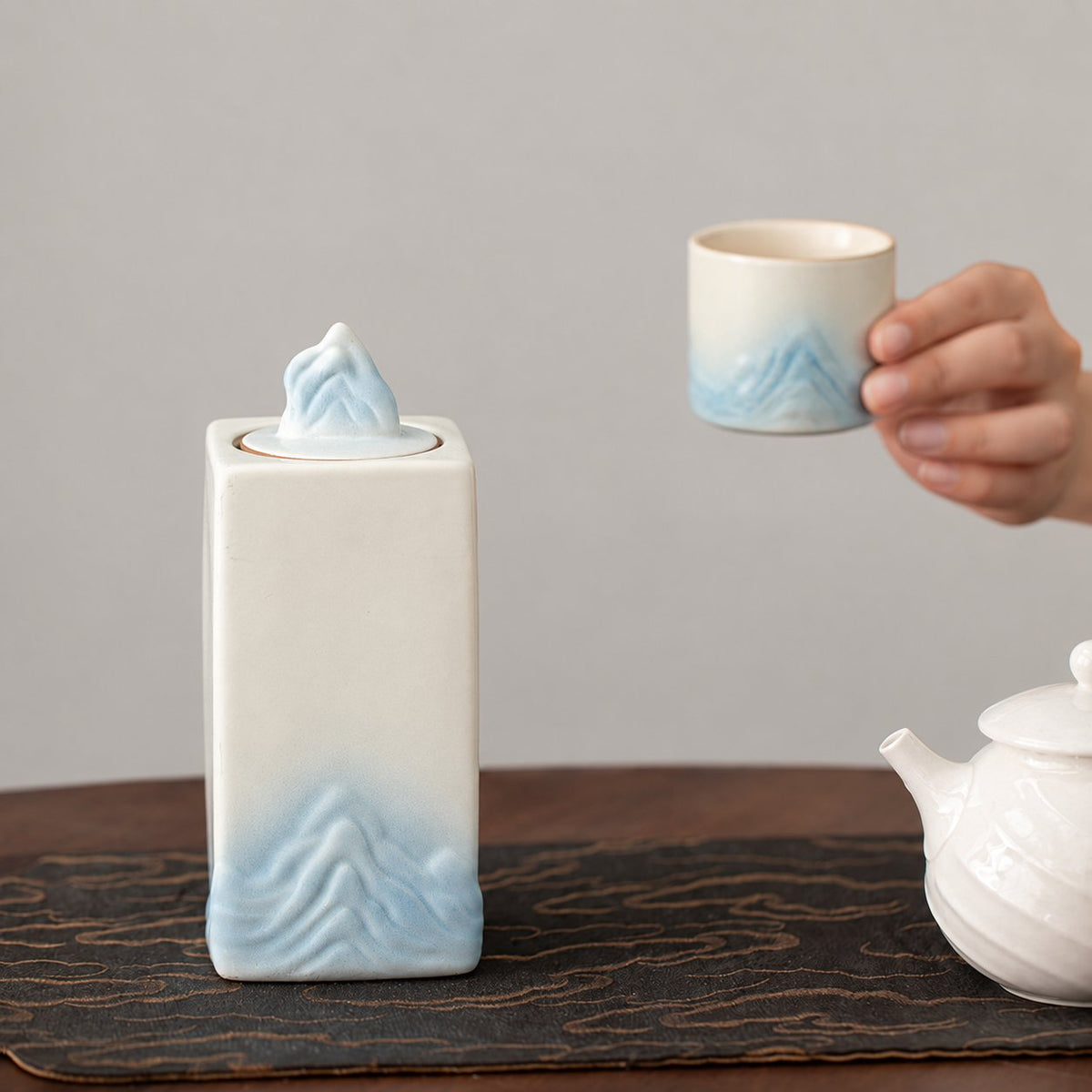 Ivory and pale blue mountain tea canister with matching tasting cup