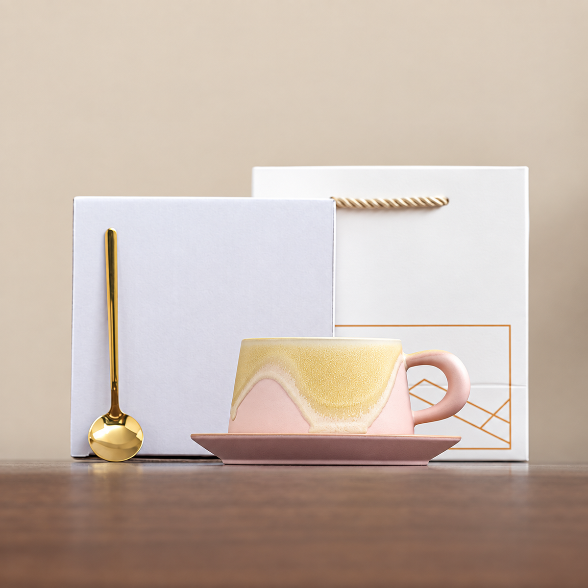 Pink wave-glaze cup and saucer with gold-tone spoon, plain box and geometric gift bag