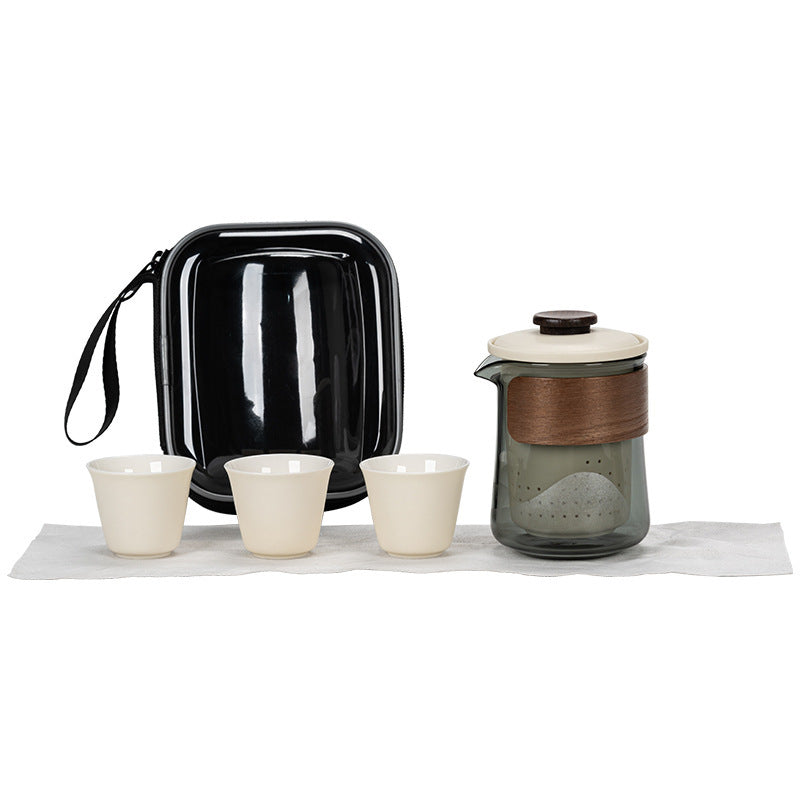 Ivory ceramic and smoked glass travel tea brewer with three cups, cloth and clear-front zip case