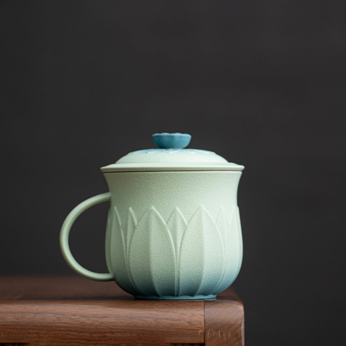 Mint and teal ceramic tea mug with lotus petal texture and matching lid