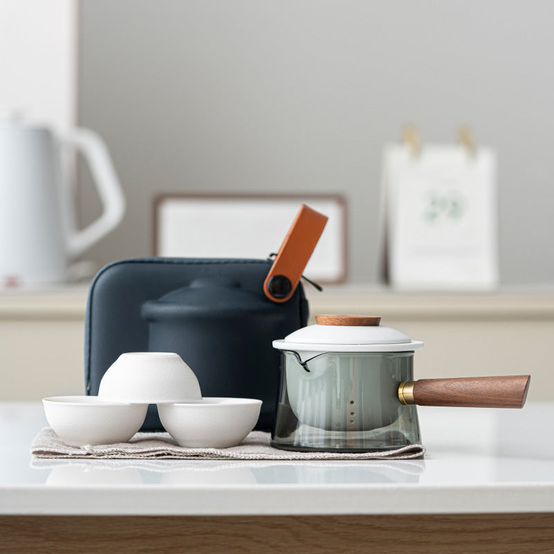Glass tea brewer and three ceramic cups in white / side handle configuration