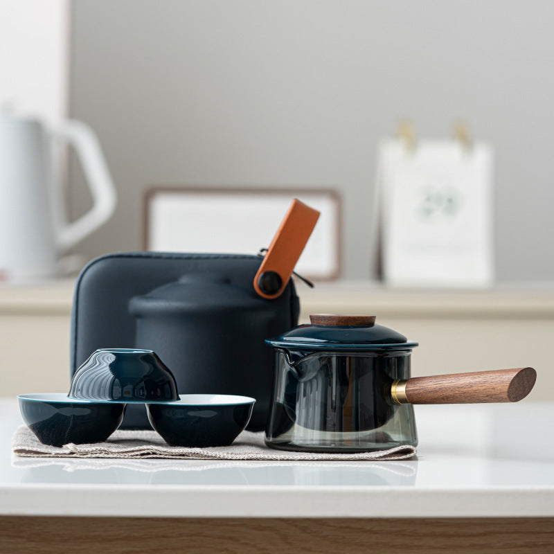 Glass tea brewer and three ceramic cups in dark blue / side handle configuration