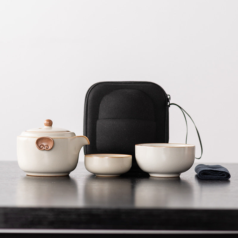 Ivory ceramic travel teapot with two nesting cups, cloth and black zip case