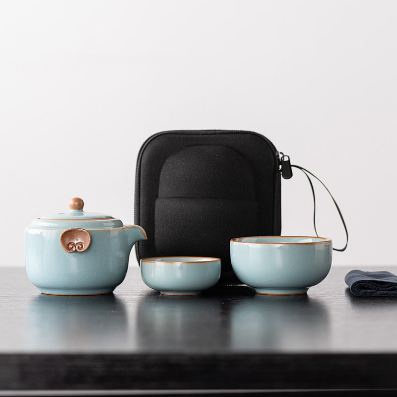 Sky blue ceramic travel teapot with two nesting cups, cloth and black zip case