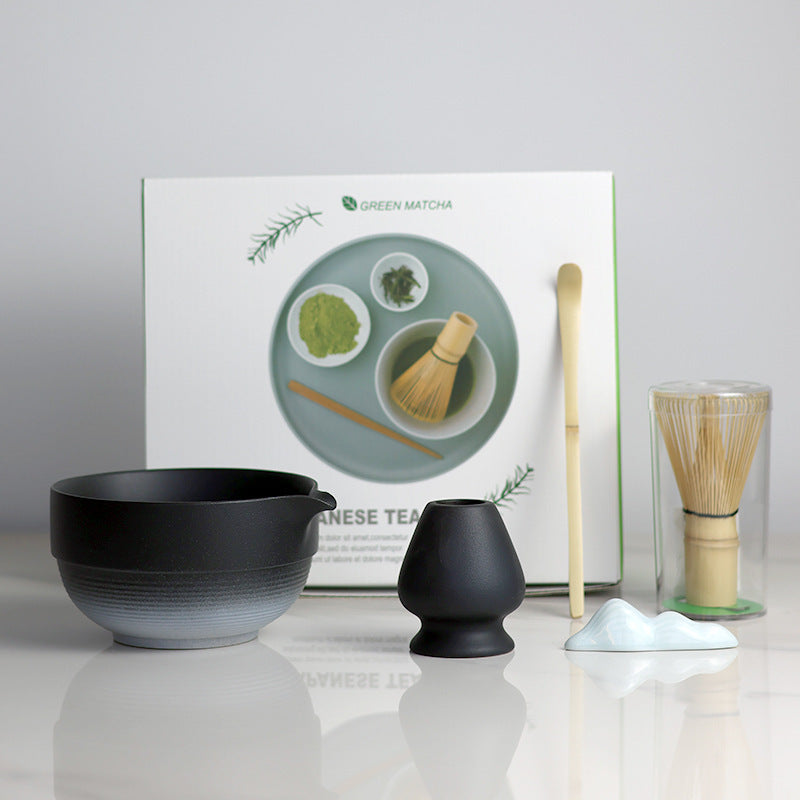 Black and White - 5 Pieces matcha set showing the bowl, holder, whisk, scoop and actual retail box, with a ceramic utensil rest