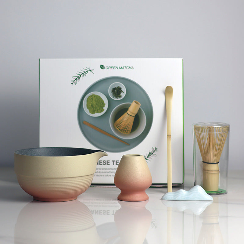 Yellow and Orange - 5 Pieces matcha set showing the bowl, holder, whisk, scoop and actual retail box, with a ceramic utensil rest