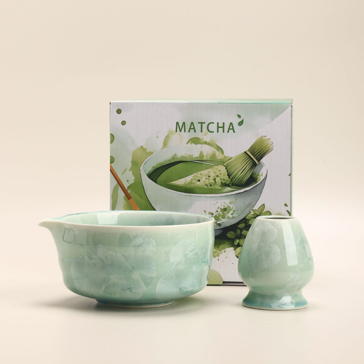 Celadon crystalline-glaze ceramic matcha bowl and whisk holder beside their English MATCHA box