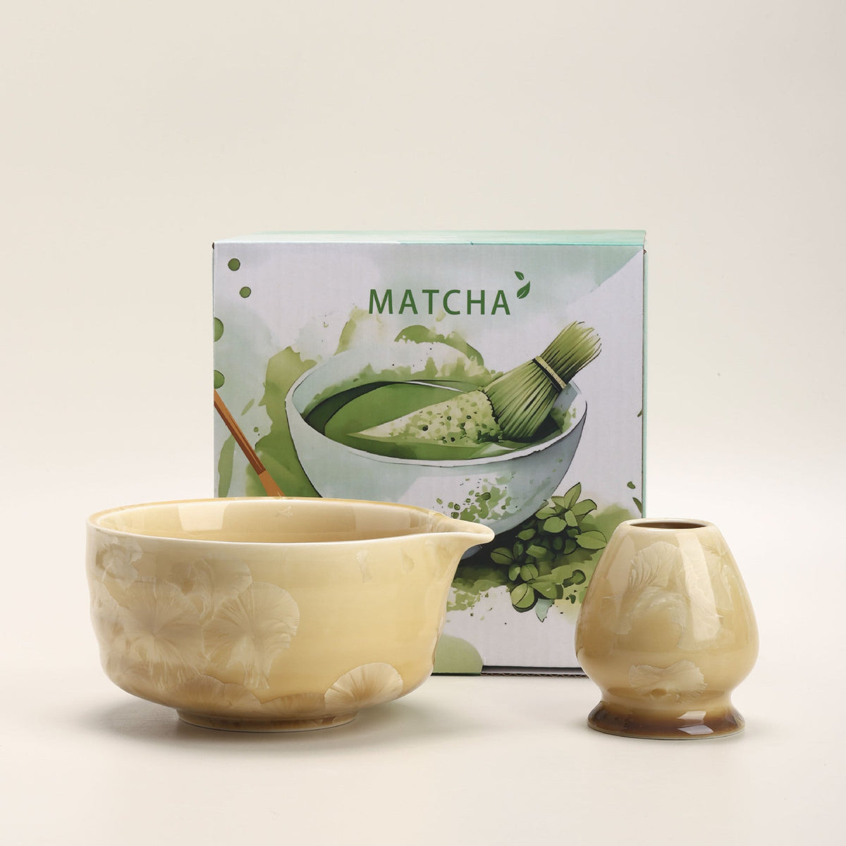 Honey crystalline-glaze ceramic matcha bowl and whisk holder beside their English MATCHA box