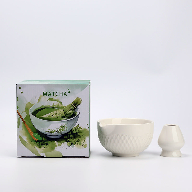 Ivory ceramic matcha bowl and holder with the associated English MATCHA carton