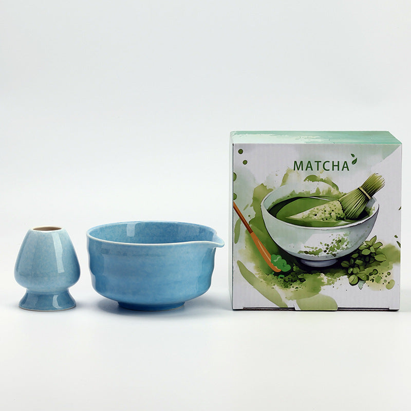 Banded Bowl - Sky Blue ceramic bowl and coordinating whisk holder beside the associated MATCHA carton