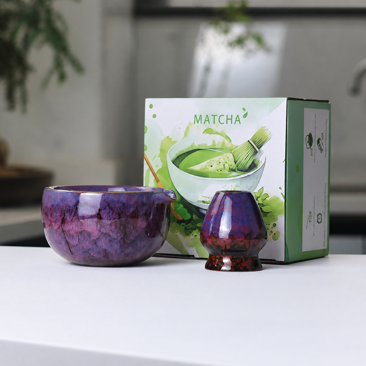 Purple mottled reactive-glaze matcha bowl and whisk holder beside the actual English MATCHA box