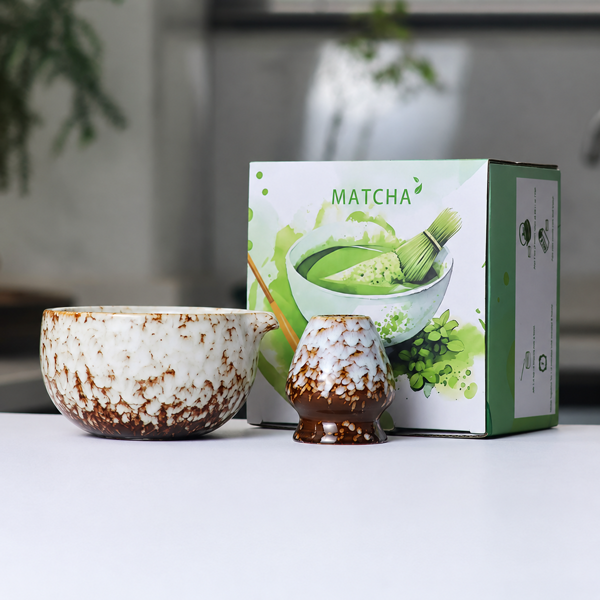 White mottled reactive-glaze matcha bowl and whisk holder beside the actual English MATCHA box