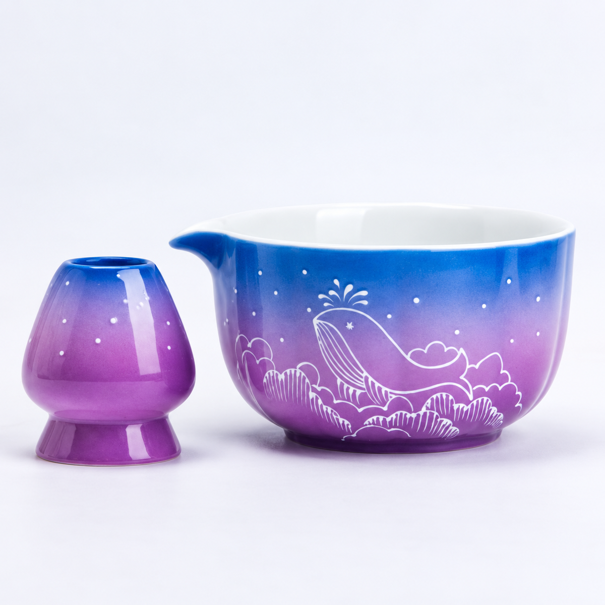 Close view of the starry whale pattern and blue-purple glaze on the matcha bowl and holder
