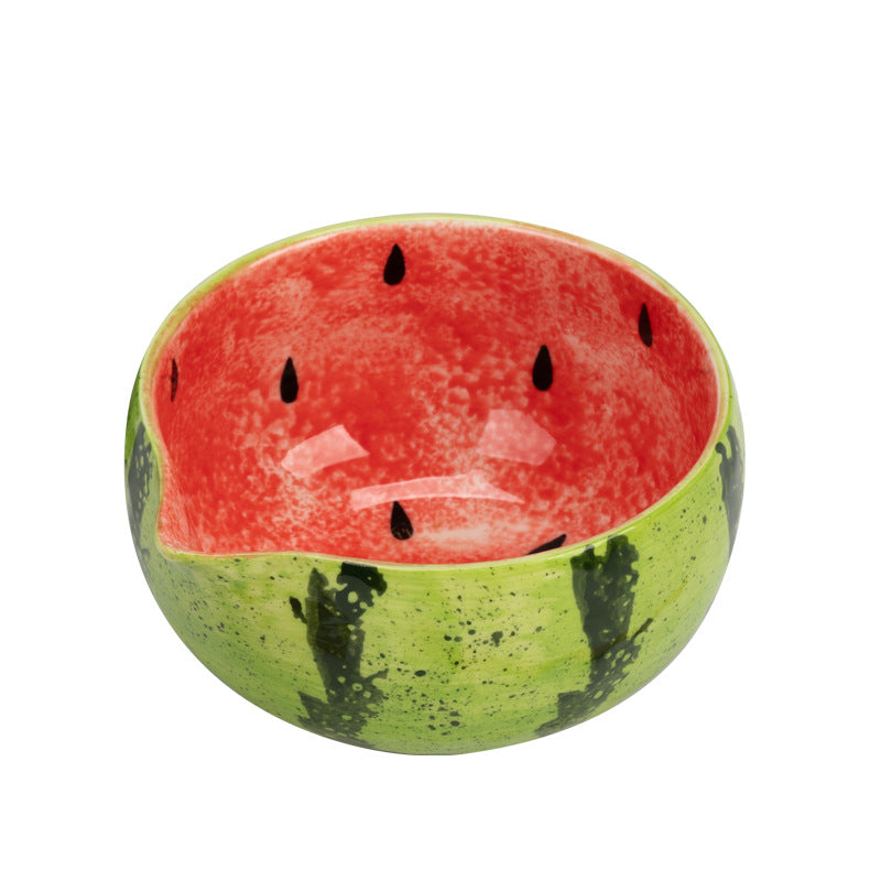 Angled overhead view of the red watermelon bowl showing the painted seeds and pouring lip
